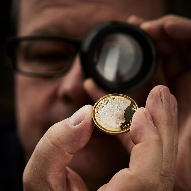 An Swissmint employee checks the quality of the commemorative coins.